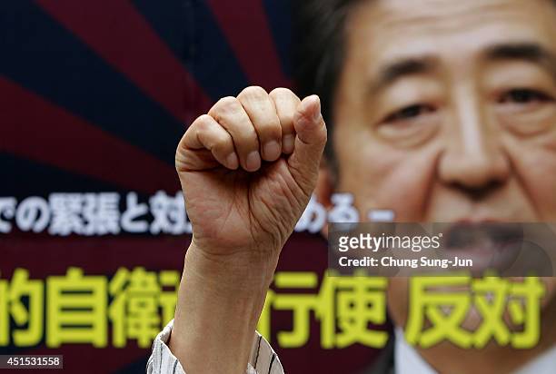 South Korean man shouts slogan during a rally at the Japanese Embassy against Japan's collective self-defense plan on July 1, 2014 in Seoul, South...