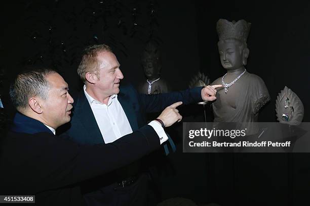 Qeelin jeweler Dennis Chan and CEO Kering Francois Henri Pinault attend the 'Qeelin' high Jewellery Exhibition opening Cocktail 'Mogoaku in Paris' at...