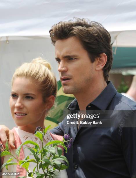 Actors Matt Bomer and Laura Ramsey on the set of "White Collar" on June 30, 2014 in New York City.