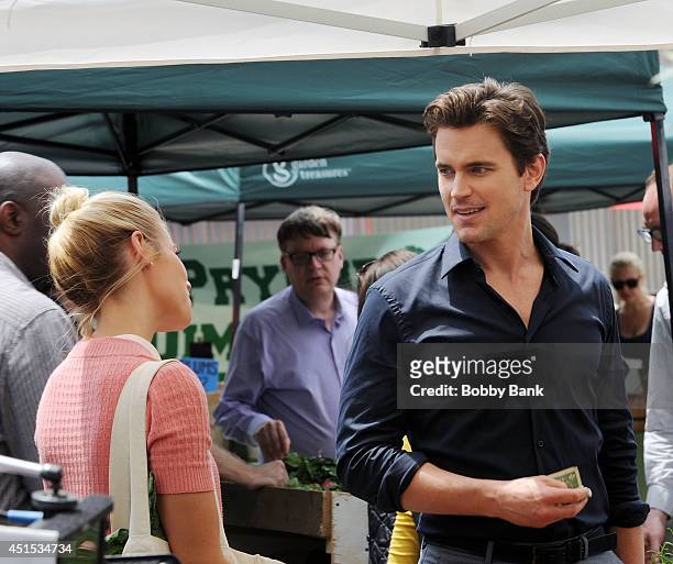 Actors Matt Bomer and Laura Ramsey on the set of "White Collar" on June 30, 2014 in New York City.