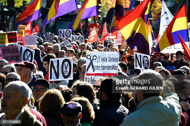 Demonstrators hold placards and flags of the Second Spanish Republic as they take part in a protest against the government's austerity measures in...