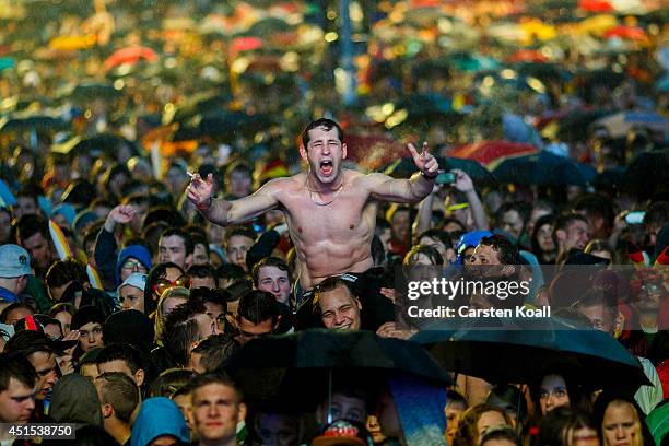 German football fan cheers enthusiastically at the screening of the Germany v Algeria Fifa World Cup match showed on a giant screen at the Hyundai...