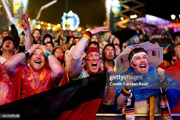 German football fans react as they watch the Germany v Algeria Fifa World Cup match on a giant screen at the Hyundai Fan Park public viewing area...