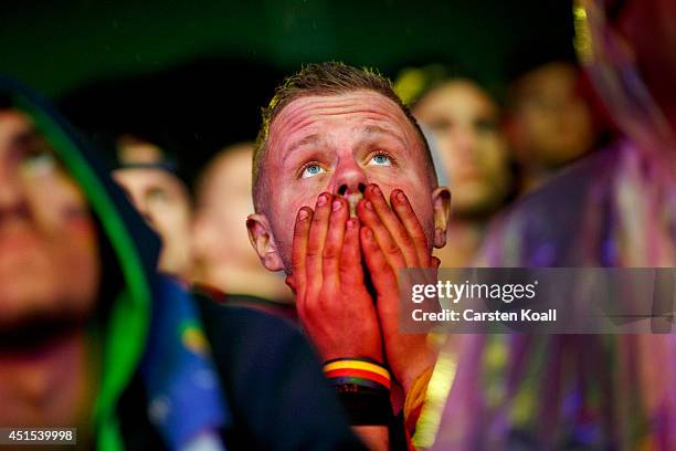 German football fan watches the Germany v Algeria Fifa World Cup match on a giant screen at the Hyundai Fan Park public viewing area named 'Fan Mile'...