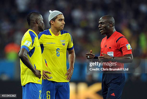 Cristhian Noboa and Enner Valencia of Ecuador complain to referee Noumandiez Doue during the 2014 FIFA World Cup Brazil Group E match between Ecuador...