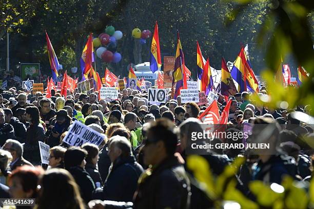 Demonstrators hold placards and flags of the Second Spanish Republic as they take part in a protest against the government's austerity measures in...