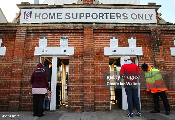 Fulham fans enter at the turnstiles prior to kickoff during the Barclays Premier League match between Fulham and Swansea City at Craven Cottage on...