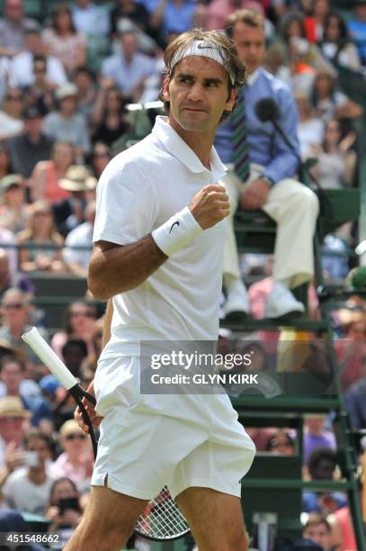 Switzerland's Roger Federer celebrates winning his men's singles fourth round match against Spain's Tommy Robredo on day eight of the 2014 Wimbledon...