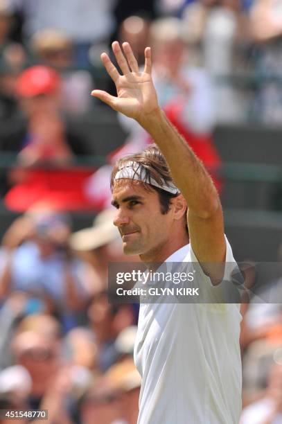 Switzerland's Roger Federer celebrates winning his men's singles fourth round match against Spain's Tommy Robredo on day eight of the 2014 Wimbledon...