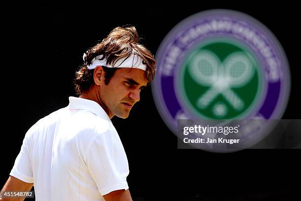 Roger Federer of Switzerland during his Gentlemen's Singles fourth round match against Tommy Robredo of Spain on day eight of the Wimbledon Lawn...