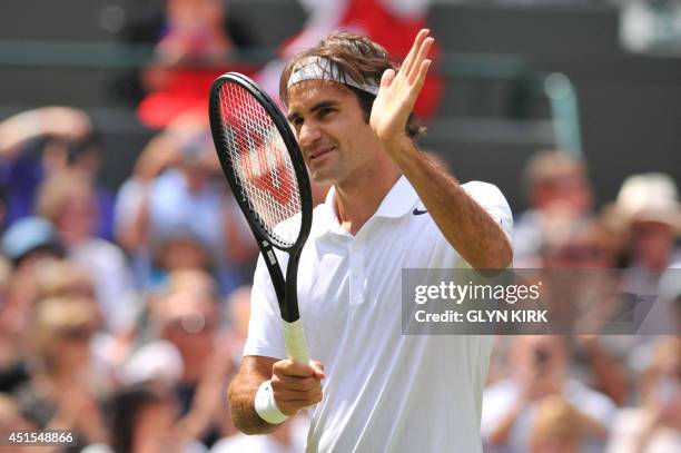 Switzerland's Roger Federer celebrates winning his men's singles fourth round match against Spain's Tommy Robredo on day eight of the 2014 Wimbledon...