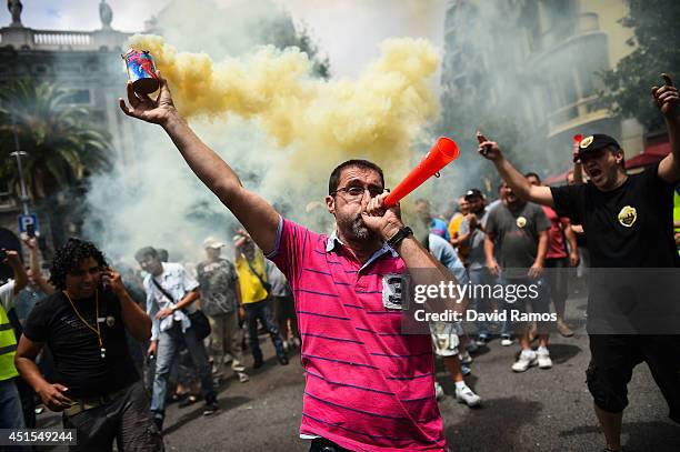 Taxi drivers protest against a new smart phones app 'Uber' during a 24 hours strike on July 1, 2014 in Barcelona, Spain. Taxi drivers in main cities...