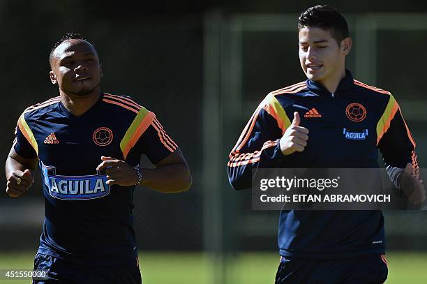 Colombia's defender Juan Camilo Zuniga and midfielder James Rodriguez take part in a training session at the President Laudo Natel Athlete Formation...