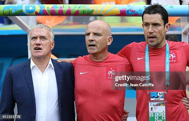 Head coach of France Didier Deschamps, assistant-coach Guy Stephan and coach of goalkeepers Franck Raviot look on during the 2014 FIFA World Cup...