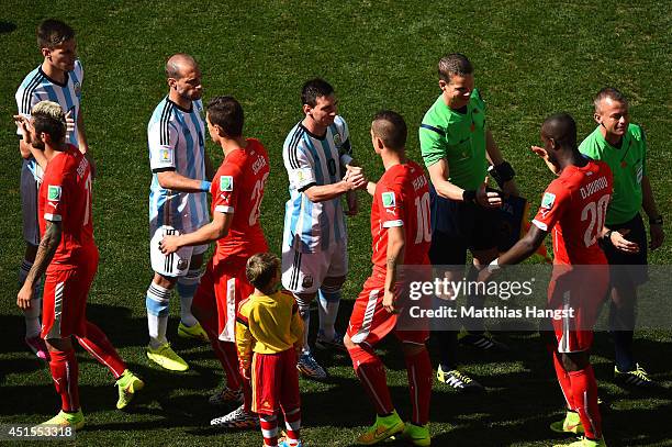 Lionel Messi of Argentina shakes hands with Granit Xhaka of Switzerland prior to the 2014 FIFA World Cup Brazil Round of 16 match between Argentina...