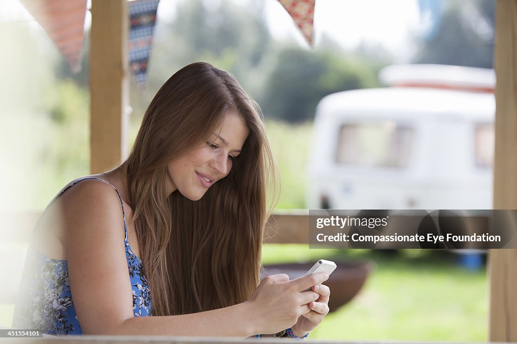 Close up of woman texting on mobile phone outdoors