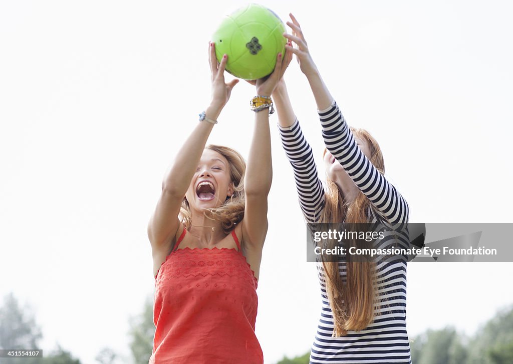 Friends catching football