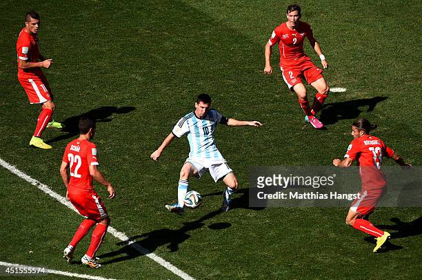 Lionel Messi of Argentina controls the ball against Josip Drmic , Fabian Schar , Stephan Lichtsteiner and Ricardo Rodriguez of Switzerland during the...