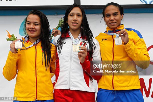 Medal winners Andres Cedron of Peru, Cindy Mejia of Colombia, and Yenny Tellez of Colombia, pose for pictures on the podium after competing in 100...
