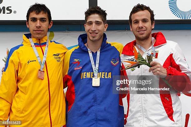 Medal winners Aziz Ramon Figarella of Venezuela, Sebastian Jahnsen of Peru, and Camilo Gamboa of Colombia, pose for pictures on the podium after...