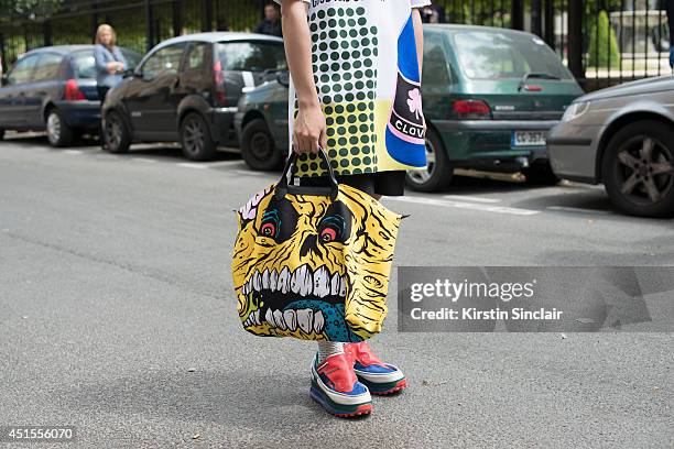 Fashion blogger Weichen Gao wearing a Raf Simons top and trainers and a Jeremy Scott bag on day 1 of Paris Collections: Men on June 25, 2014 in...