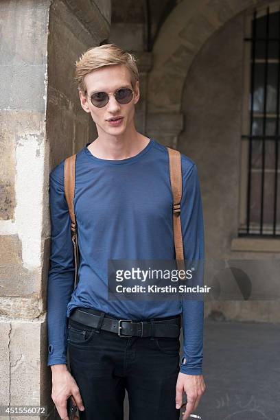Model Paul Boche wearing vintage Ray Ban sunglasses and vintage bag, Nicholas K top and Rag and Bone jeans on day 1 of Paris Collections: Men on June...