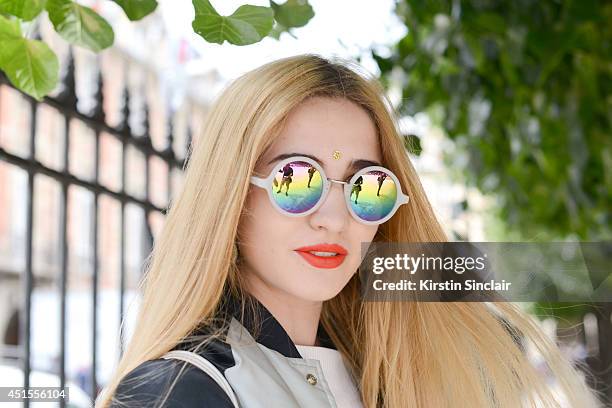 Fashion blogger Elisa Baudoin wearing Asos sunglasses, H and M top, vintage jacket on day 1 of Paris Collections: Men on June 25, 2014 in Paris,...