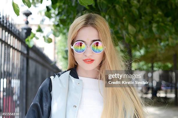 Fashion blogger Elisa Baudoin wearing Asos sunglasses, H and M top, vintage jacket on day 1 of Paris Collections: Men on June 25, 2014 in Paris,...