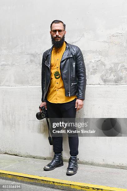 Fashion photographer Antonio Giacometti wearing H and M shirt and jeans, vintage jacket,Costume Nationale boots and vintage Lozza sunglasses on day 1...