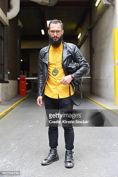 Fashion photographer Antonio Giacometti wearing H and M shirt and jeans, Costume Nationale boots, vintage jacket and vintage Lozza sunglasses on day...