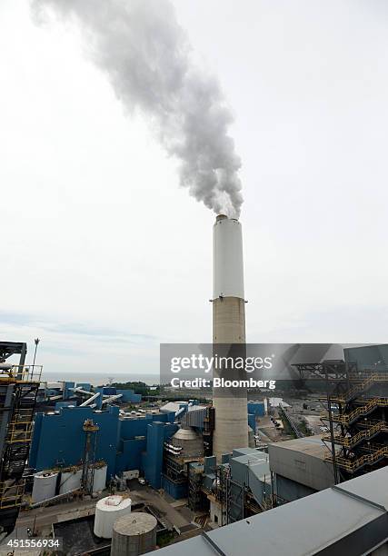 Steam rises from a tower at DTE Energy Co.'s Monroe Power Plant in Monroe, Michigan, U.S., on Monday, June 30, 2014. DTE Energy's Monroe plant is the...