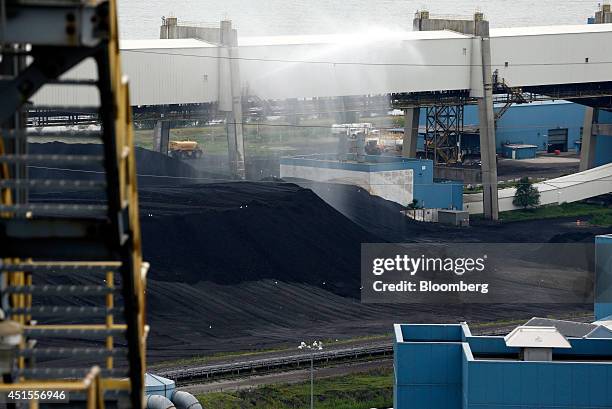 Piles of coal sit outside DTE Energy Co.'s Monroe Power Plant in Monroe, Michigan, U.S., on Monday, June 30, 2014. DTE Energy's Monroe plant is the...