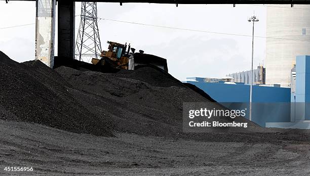 Piles of coal sit outside DTE Energy Co.'s Monroe Power Plant in Monroe, Michigan, U.S., on Monday, June 30, 2014. DTE Energy's Monroe plant is the...