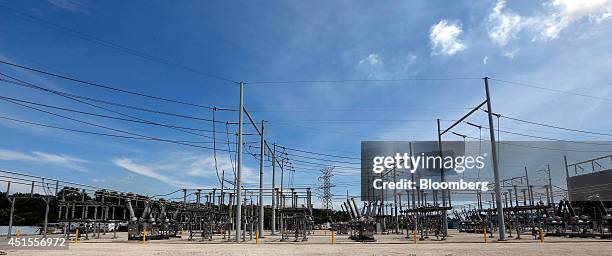Transmission lines carry electricity at DTE Energy Co.'s Monroe Power Plant in Monroe, Michigan, U.S., on Monday, June 30, 2014. DTE Energy's Monroe...