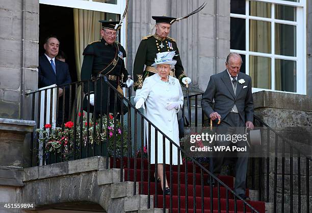 Queen Elizabeth II and Prince Philip, Duke of Edinburgh meet guests at a Garden Party at the Palace of Holyroodhouse on July 1, 2014 in Edinburgh,...