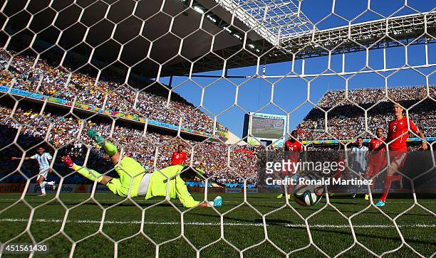 Angel di Maria of Argentina scores is team's first goal past Diego Benaglio of Switzerland in extra time during the 2014 FIFA World Cup Brazil Round...