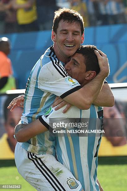 Argentina's forward and captain Lionel Messi and Argentina's midfielder Angel Di Maria celebrate after scoring the 1-0 during of a Round of 16...
