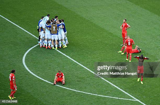 Argentina players celebrate defeating Switzerland 1-0 in extra time in the 2014 FIFA World Cup Brazil Round of 16 match between Argentina and...