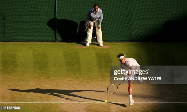 Spain's Rafael Nadal serves against Australia's Nick Kyrgios during their men's singles fourth round match on day eight of the 2014 Wimbledon...