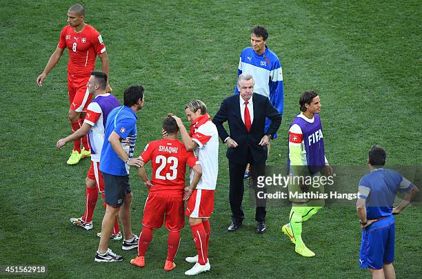 Head coach Ottmar Hitzfeld of Switzerland looks on with his players after being defeated by Argentina 1-0 in extra time during the 2014 FIFA World...