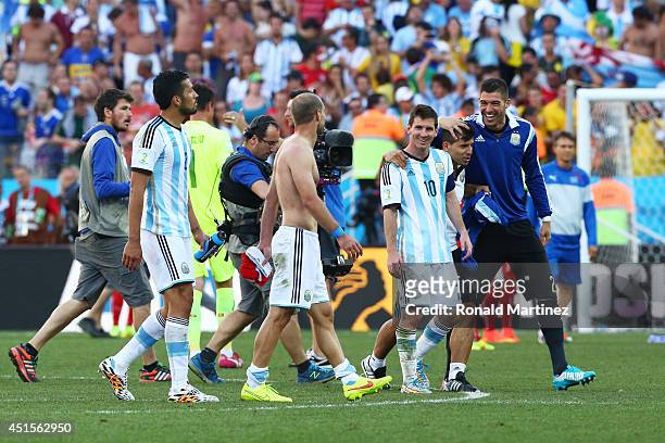 Lionel Messi of Argentina celebrates with teammates after defeating Switzerland 1-0 in extra time during the 2014 FIFA World Cup Brazil Round of 16...
