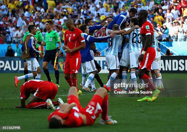Argentina players celebrate defeating Switzerland 1-0 in extra time in the 2014 FIFA World Cup Brazil Round of 16 match between Argentina and...