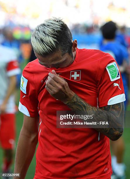 Valon Behrami of Switzerland shows his dejection as he walks off the pitch after the 0-1 defeat in the 2014 FIFA World Cup Brazil Round of 16 match...