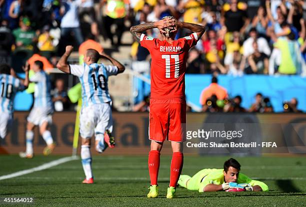 Valon Behrami and Diego Benaglio of Switzerland react after conceding the first goal to Argentina during the 2014 FIFA World Cup Brazil Round of 16...