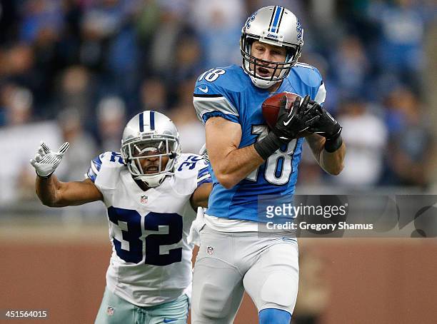 Kris Durham of the Detroit Lions catches a fourth quarter pass in front of Orlando Scandrick of the Dallas Cowboys at Ford Field on October 27, 2013...