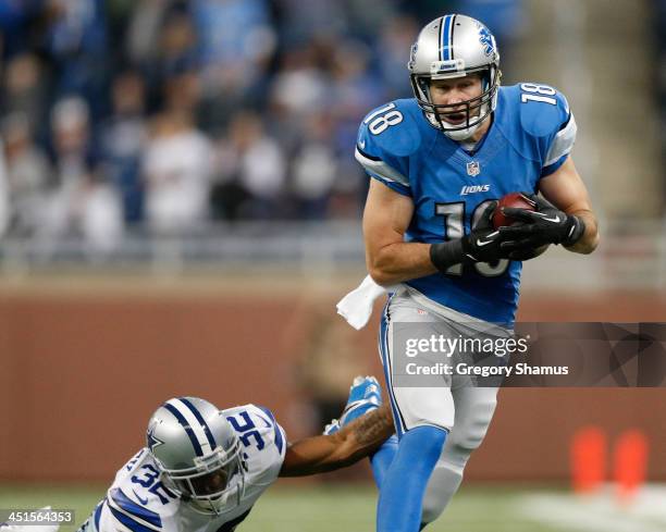 Kris Durham of the Detroit Lions catches a fourth quarter pass in front of Orlando Scandrick of the Dallas Cowboys at Ford Field on October 27, 2013...