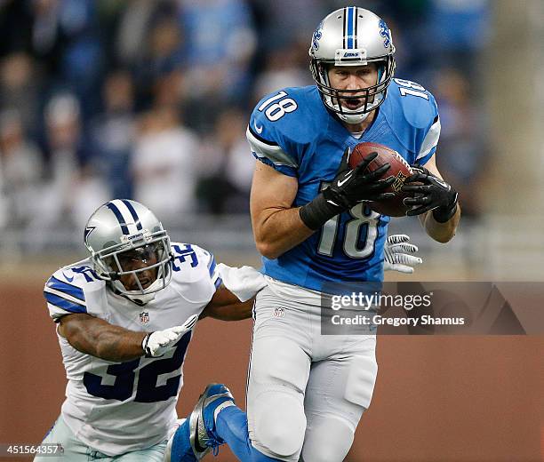 Kris Durham of the Detroit Lions catches a fourth quarter pass in front of Orlando Scandrick of the Dallas Cowboys at Ford Field on October 27, 2013...