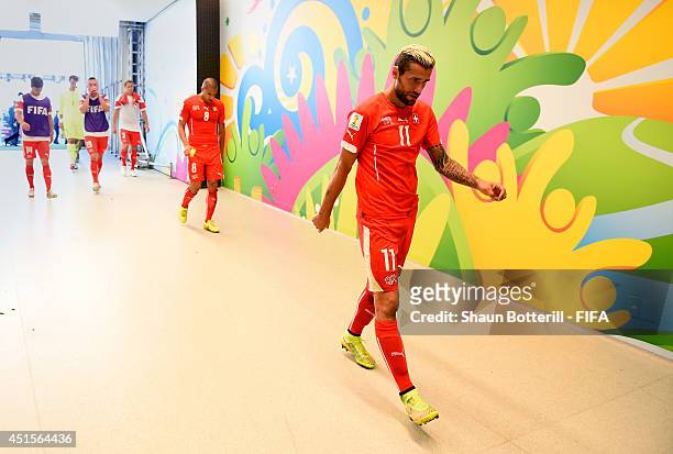 Valon Behrami of Switzerland shows his dejection in the tunnel after the 0-1 defeat in the 2014 FIFA World Cup Brazil Round of 16 match between...