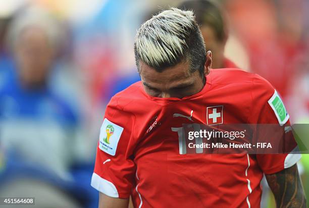 Valon Behrami of Switzerland shows his dejection as he walks off the pitch after the 0-1 defeat in the 2014 FIFA World Cup Brazil Round of 16 match...