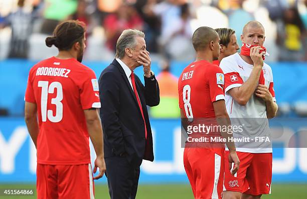Head coach Ottmar Hitzfeld of Switzerland reacts next to Ricardo Rodriguez of Switzerland and Gokhan Inler of Switzerland after the 0-1 defeat in the...